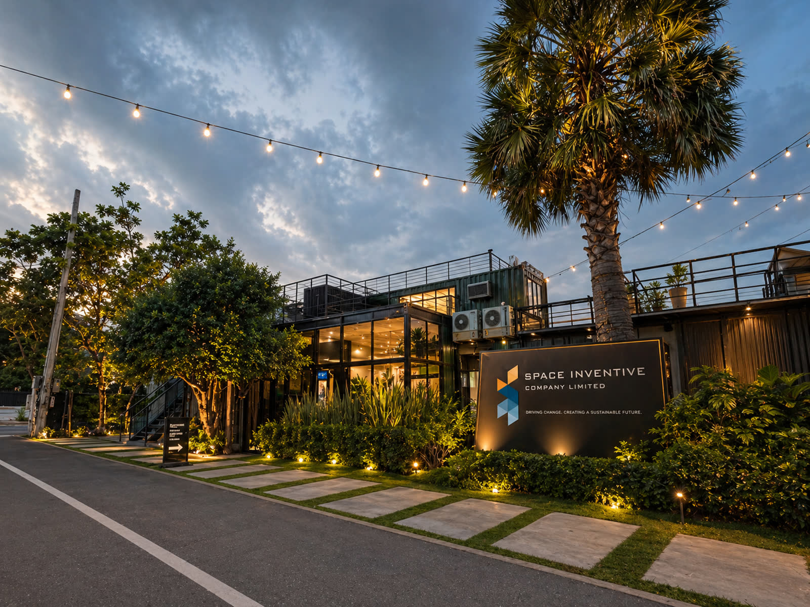 Space Inventive HQ — exterior at dusk with string lights